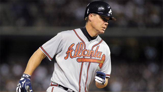 Chipper Jones, third baseman for the Atlanta Braves, blows a