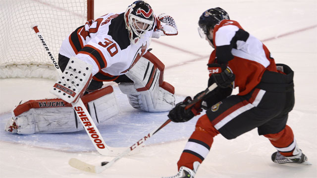 New Jersey Devils center Travis Zajac (19) checks Ottawa Senators