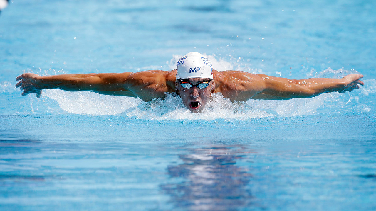 Michael Phelps competes in the preliminary round of the men's 200 mete...
