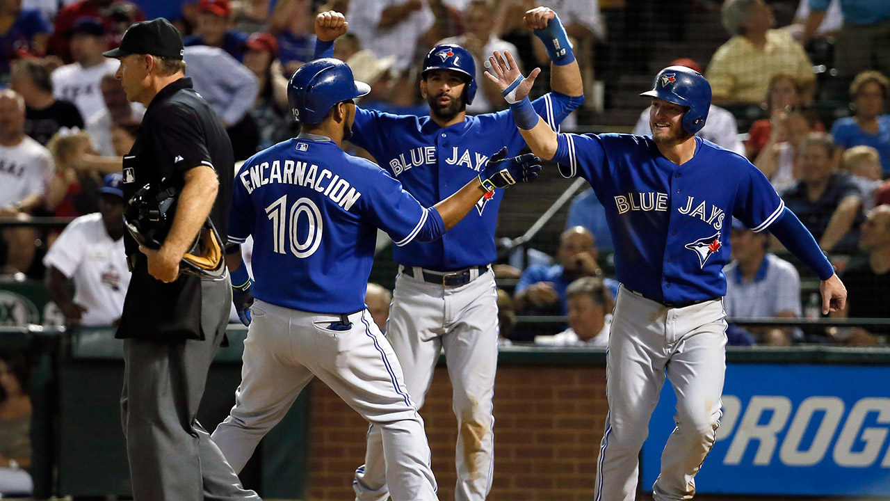 Blue Jays Encarnacion and Bautista warm up under red sky while the