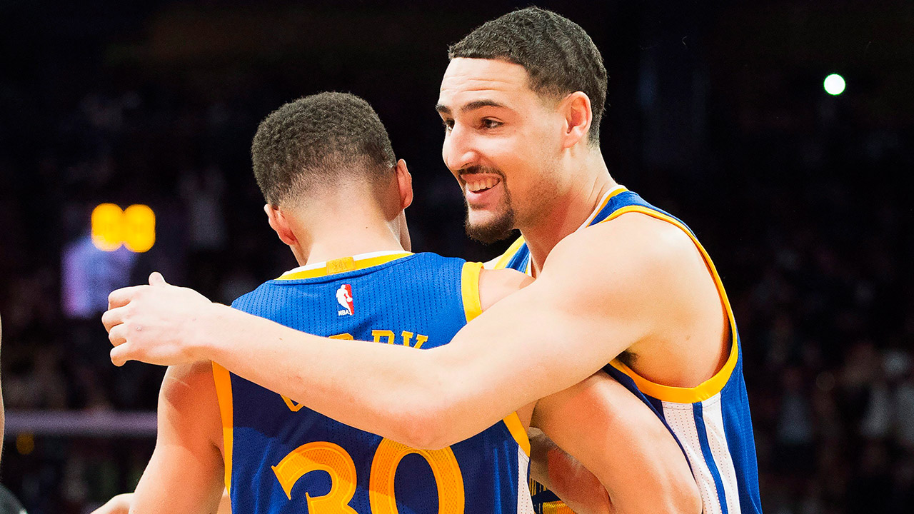 Golden State Warriors guard Klay Thompson (11) hugs Golden State Warriors guard Stephen Curry (30). (Mark Blinch/CP)