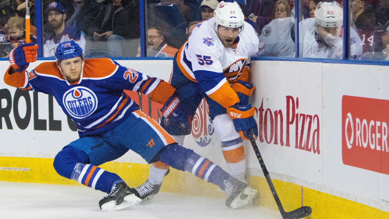 New-York-Islanders'-Johnny-Boychuk-(55)-gets-to-the-puck-ahead-of-Edmonton-Oilers'-Leon-Draisaitl-(29)-during-second-period-NHL-hockey-action,-in-Edmonton-on-Sunday,-Feb.-28,-2016.-THE-CANADIAN-PRESS/Amber-Bracken