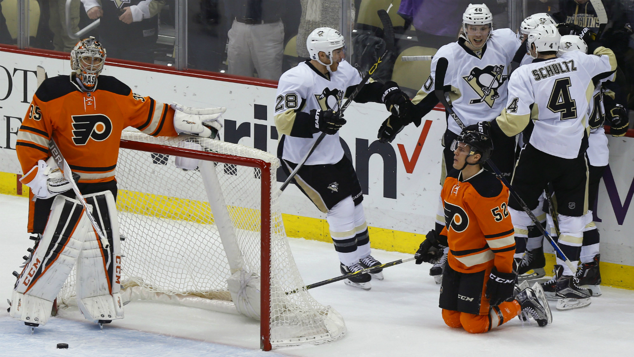 The-Pittsburgh-Penguins-Ian-Cole-(28),-Justin-Schultz-(4)-and-Oskar-Sundqvist-(40)-celebrate-a-goal-by-teammate-Beau-Bennett-in-the-first-period-against-Philadelphia-Flyers-goalie-Steve-Mason,-left,-as-Flyers'-Nick-Cousins-(52)-kneels-on-the-ice-during-an-NHL-hockey-game,-Sunday,-April-3,-2016,-in-Pittsburgh.-(AP-Photo/Keith-Srakocic)