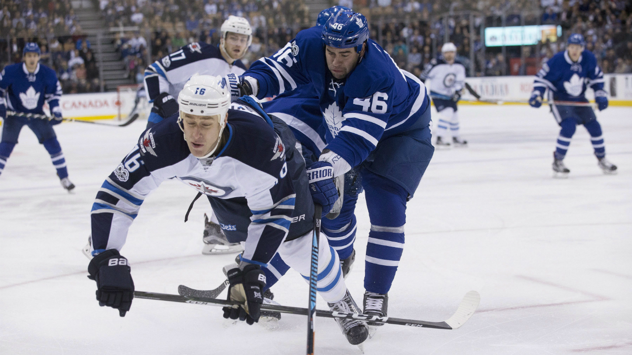 Winnipeg-Jets-left-wing-Shawn-Matthias-(16)-gets-pushed-off-the-puck-by-Toronto-Maple-Leafs-defenceman-Roman-Polak-(46)-during-first-period-NHL-hockey-action,-in-Toronto-on-Tuesday,-February-21,-2017.-(Chris-Young/CP)