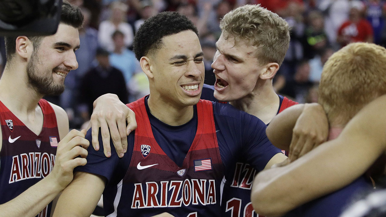 Arizona's Dusan Ristic, Chance Comanche and Lauri Markkanen, from left, celebrate after Arizona defeated Oregon 83-80 in an NCAA college basketball game for the championship of the Pac-12 men's tournament Saturday, March 11, 2017, in Las Vegas. (AP Photo/John Locher)