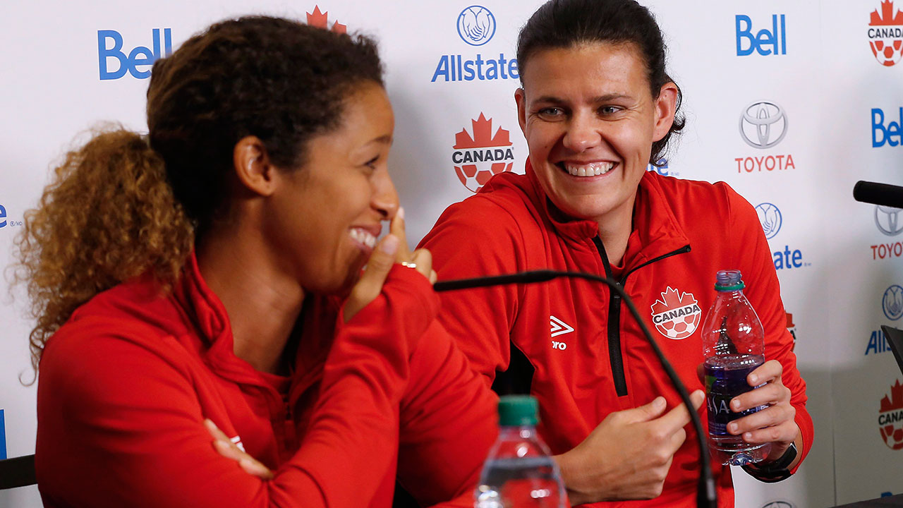 Team-Canada-soccer-players-Desiree-Scott-and-Christine-Sinclair-joke-around-during-a-press-conference-in-Winnipeg,-Tuesday,-June-6,-2017-prior-to-their-match-against-Costa-Rica-on-Thursday.-Sinclair-always-has-the-spotlight-on-her,-but-the-veteran-captain-says-soccer-fans-should-keep-an-eye-on-her-young,-talented-teammates.-(John-Woods/CP)