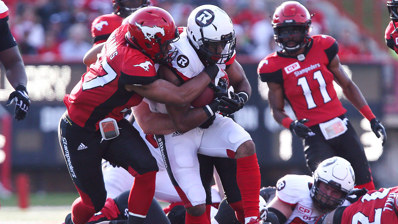 Calgary-Stampeders'-Maleki-Harris-(37)-tackles-Ottawa-Redblacks'-Mossis-Madu-Jr.-in-first-quarter-CFL-action-in-Calgary,-Thursday,-June-29,-2017.-(Mike-Ridewood/CP)