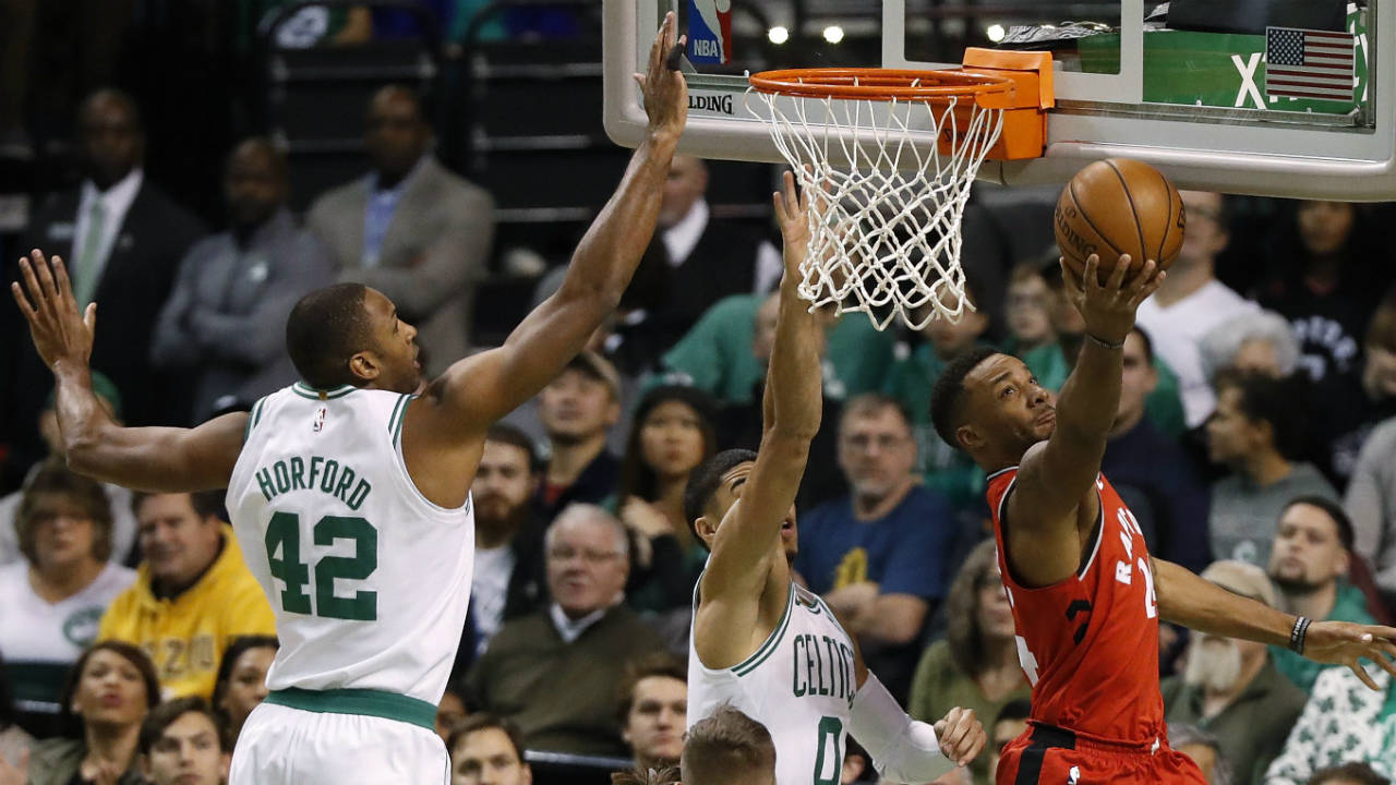 Toronto-Raptors'-Norman-Powell,-right,-goes-under-the-basket-to-shoot-past-Boston-Celtics'-Jayson-Tatum-and-Al-Horford-(42)-during-the-first-quarter-of-an-NBA-basketball-game-in-Boston-Sunday,-Nov.-12,-2017.-(Winslow-Townson/AP)