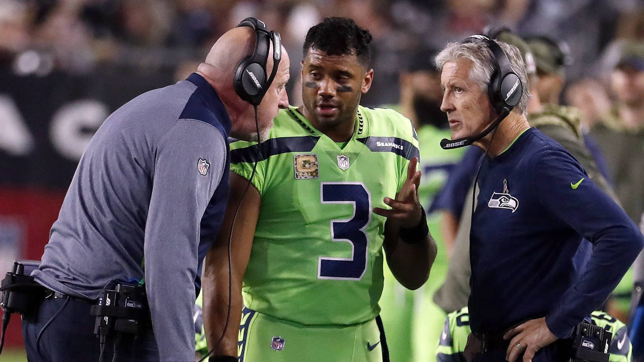 In-this-Thursday,-Nov.-9,-2017,-file-photo,-Seattle-Seahawks-quarterback-Russell-Wilson-(3)-speaks-with-head-coach-Pete-Carroll,-right,-and-assistant-head-coach-Tom-Cable-during-an-NFL-football-game-against-the-Arizona-Cardinals-in-Glendale,-Ariz.-The-Seahawks-return-to-practice-Tuesday,-Nov.-14,-2017,-without-Richard-Sherman-and-facing-questions-about-how-the-team-handled-the-concussion-protocol-with-quarterback-Russell-Wilson.-(Rick-Scuteri,-File/AP)