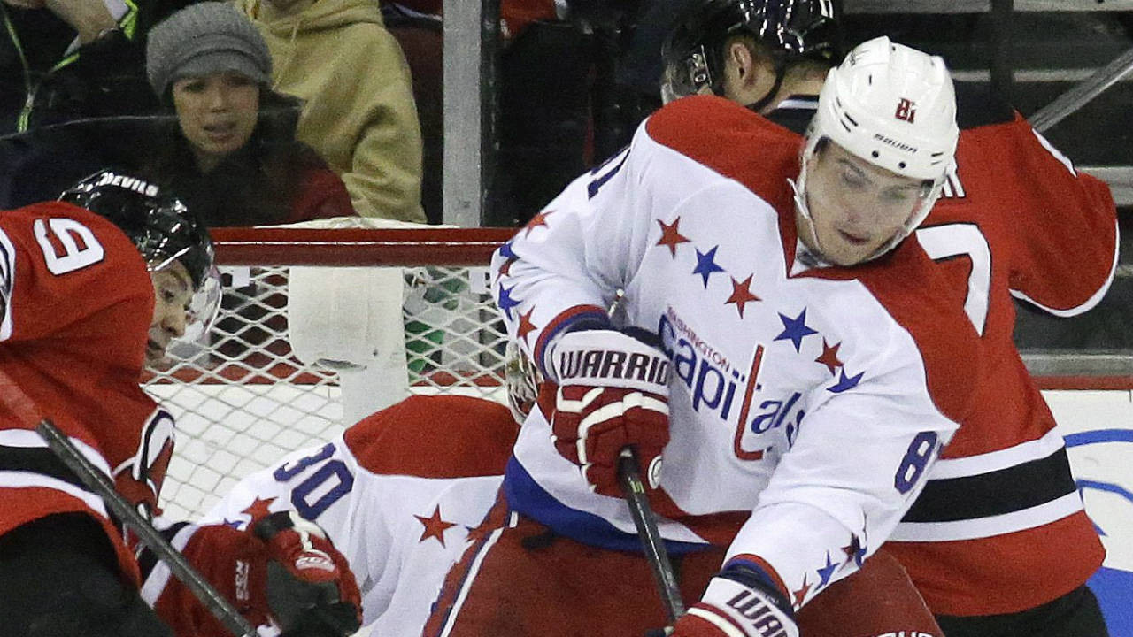 Washington-Capitals-defenseman-Dmitry-Orlov,-right,-of-Russia,-takes-the-puck-away-from-New-Jersey-Devils-forward-Joe-Whitney,-left,-during-Whitney's-NHL-debut-in-the-first-period-of-an-NHL-hockey-game,-Friday,-Jan.-24,-2014,-in-Newark,-N.J.-(Julio-Cortez/AP)