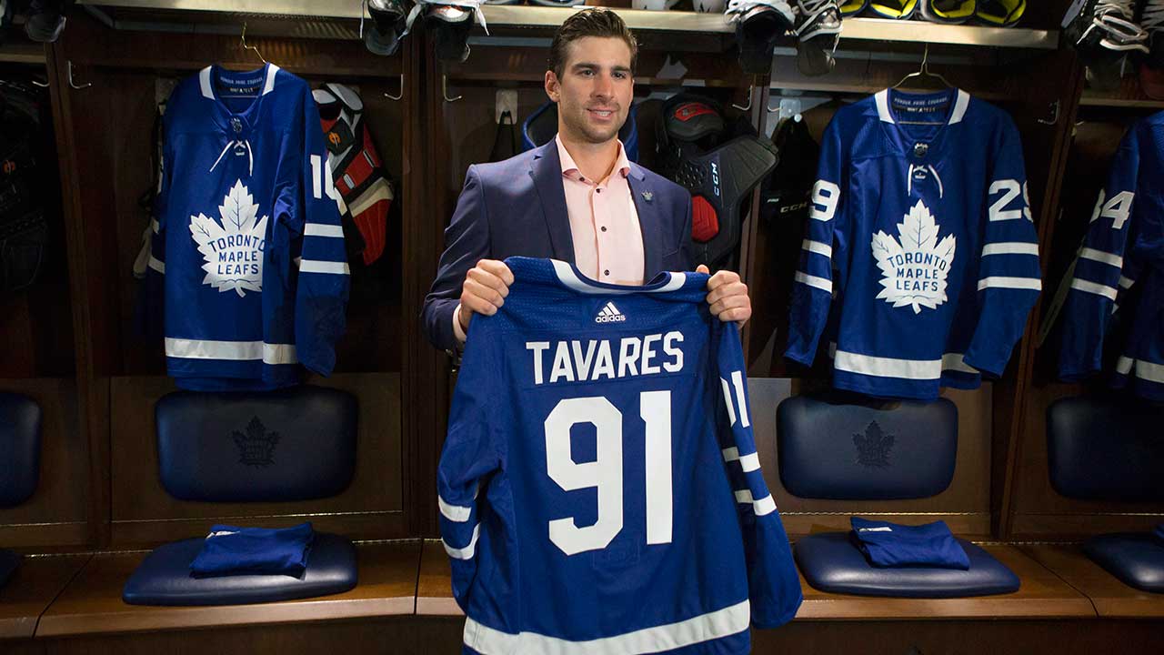 john-tavares-holds-up-maple-leafs-jersey