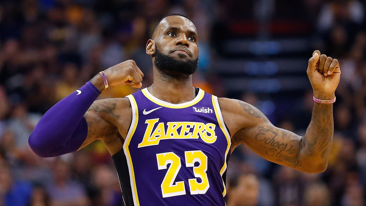 Los Angeles Lakers forward LeBron James tosses his warm up jacket