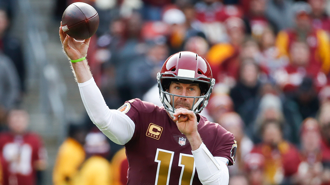 Washington Redskins quarterback Alex Smith (11) tosses a pass