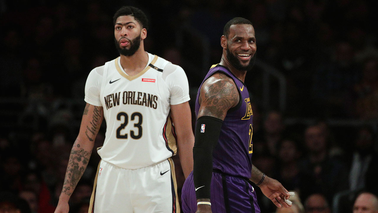 lebron-james-smiles-as-he-walks-past-anthony-davis