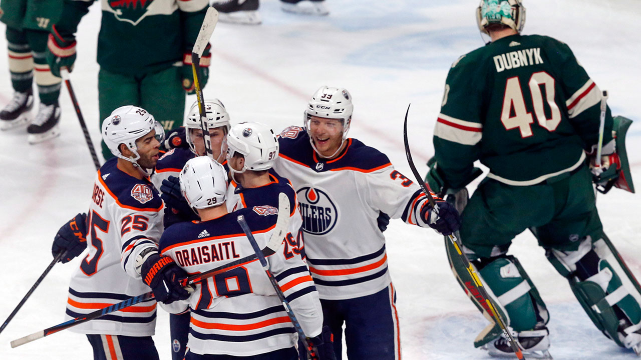 leon-draisaitl-celebrates-scoring-a-goal-with-teammates