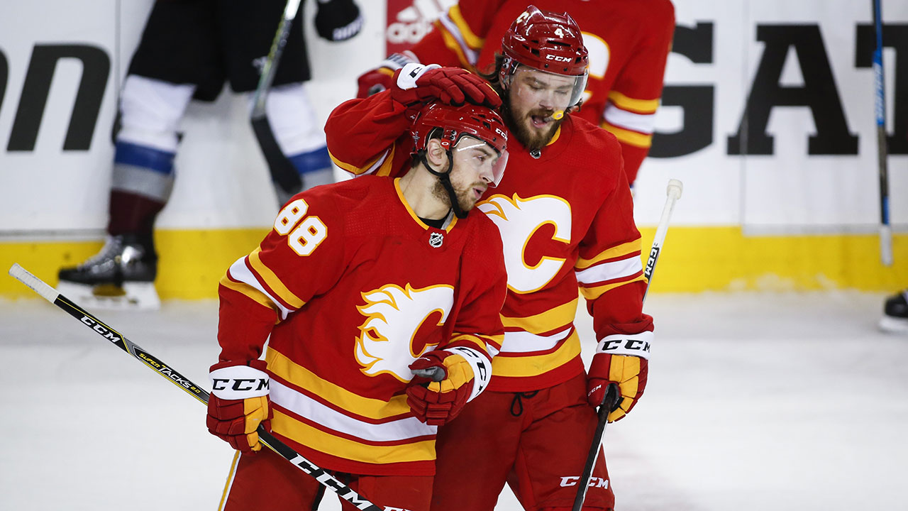 Calgary Flames' Andrew Mangiapane, right, celebrates his goal with