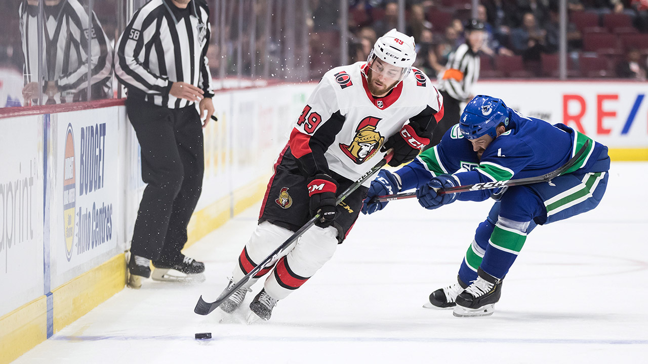 canucks-jordie-benn-checks-senators-scott-sabourin