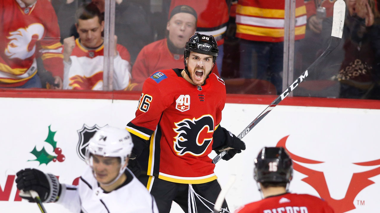 Calgary Flames' Zac Rinaldo, top, celebrates. (Larry MacDougal/CP)