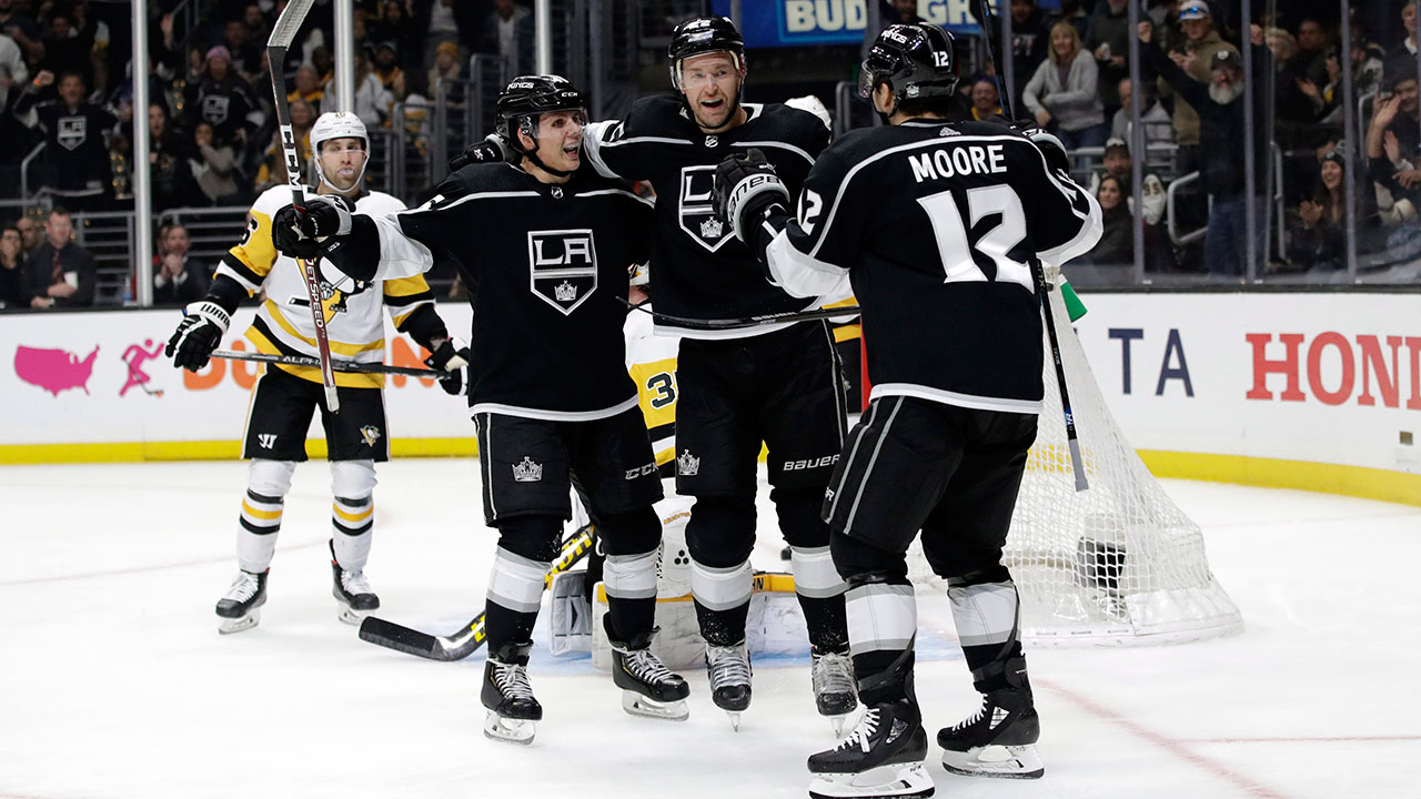 The Los Angeles Kings' Trevor Lewis, centre, celebrates his goal with Blake Lizotte, left, and Trevor Moore (12). (Marcio Jose Sanchez/AP)