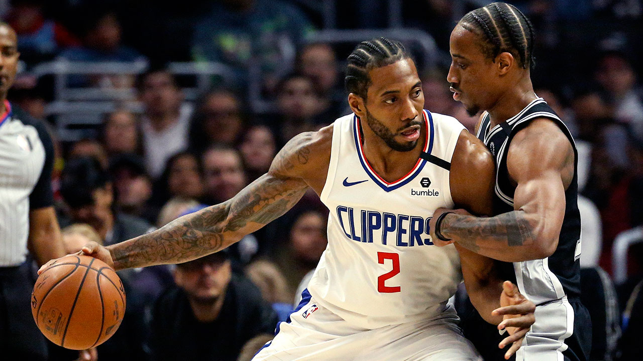 Los Angeles Clippers' Kawhi Leonard (2) is defended by San Antonio Spurs' DeMar DeRozan (10) during the first half of an NBA basketball game, Monday, Feb. 3, 2020, in Los Angeles. (Ringo H.W. Chiu / AP)