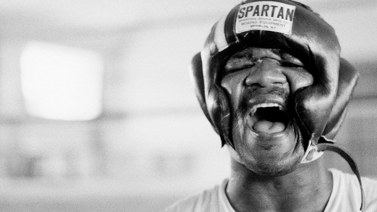 George-Foreman-laughs-under-his-headgear-during-a-training-session-1974