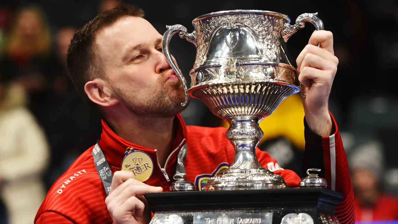 Brad Gushue kisses the Brier tankard after winning his third Canadian men's curling championship Sunday in Kingston, Ont. (Sean Kilpatrick/CP)