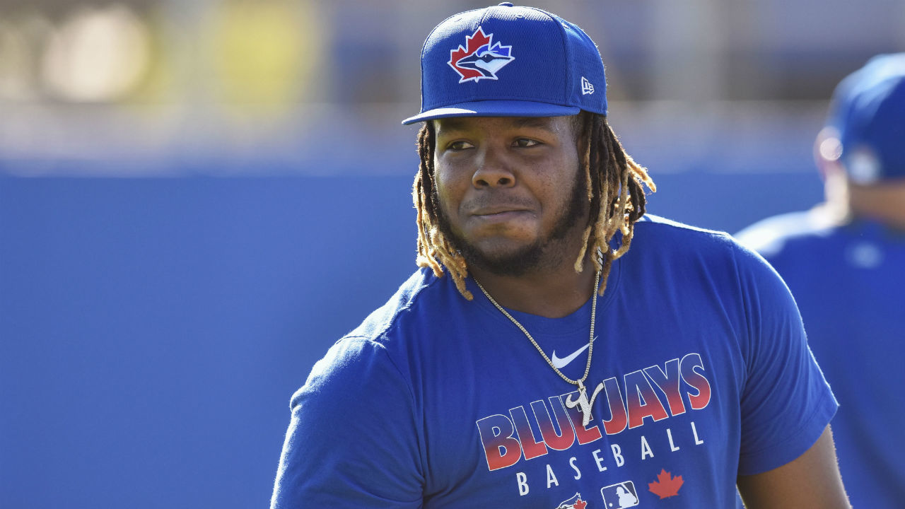 TORONTO, ON - APRIL 11: Toronto Blue Jays first baseman Vladimir Guerrero  Jr. (27) poses for the cameras after the opening ceremony pitch from Former Blue  Jays first baseman and recent Hall