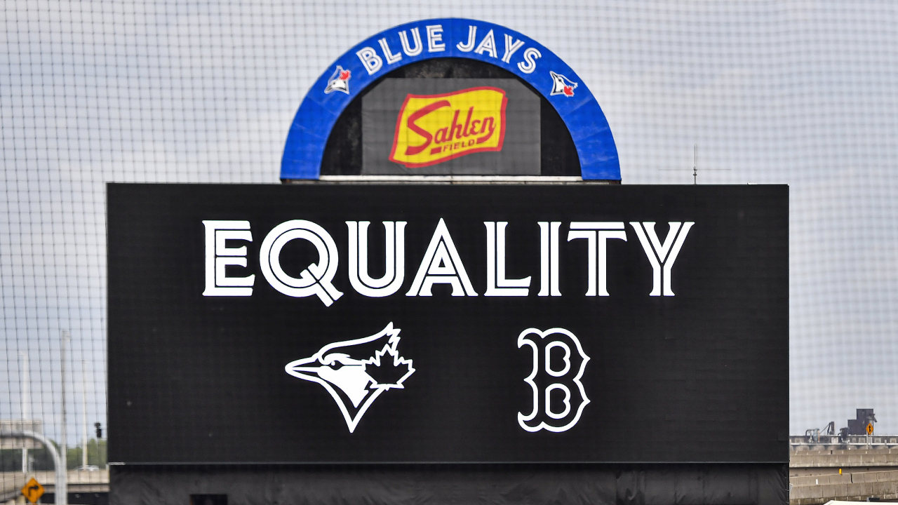 The scoreboard read "Equality" as a Boston Red Sox player warms up in the outfield at Sahlen Field before a baseball game against the Toronto Blue Jays in Buffalo, N.Y., Thursday, Aug. 27, 2020. (Adrian Kraus/AP)