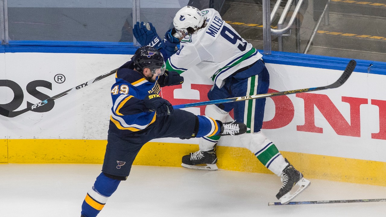 St. Louis Blues forward Ivan Barbashev (49) checks Vancouver Canucks forward J.T. Miller (9). (Jason Franson/CP)