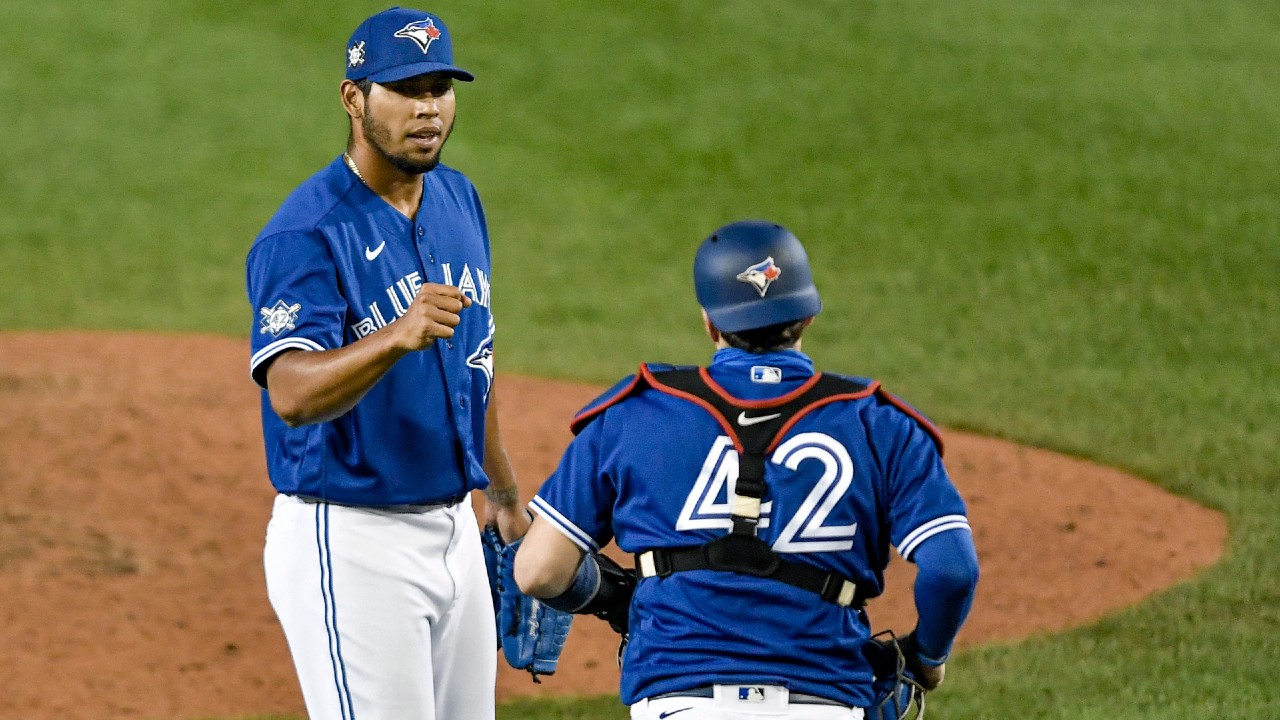 Toronto Blue Jays catcher Danny Jansen (9) gives a forearm bump to