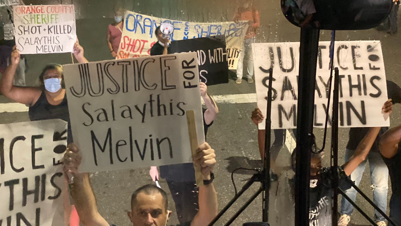 A group of protesters at the NBA Bubble stop the media bus at the cross section of Coronado Springs and Buena Vista Dr., seeking justice for Salaythis Melvin. (Ben Golliver/The Washington Post)