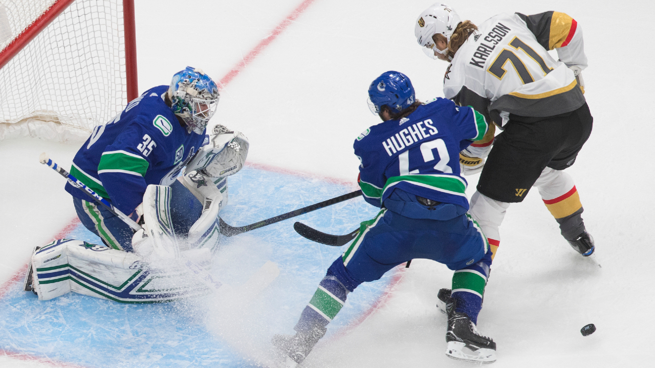 Vancouver Canucks goalie Thatcher Demko (35) makes the save as Vegas Golden Knights' William Karlsson (71) and Canucks' Quinn Hughes (43) battle for the rebound during second period NHL Western Conference Stanley Cup playoff action in Edmonton on Thursday, September 3, 2020. (Jason Franson/CP)
