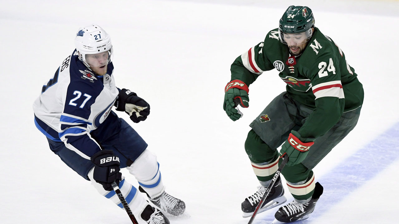 Winnipeg Jets' Nikolaj Ehlers (27), of Denmark, gets the puck away from Minnesota Wild's Matt Dumba (24) during the third period of an NHL hockey game. (Hannah Foslien/AP)