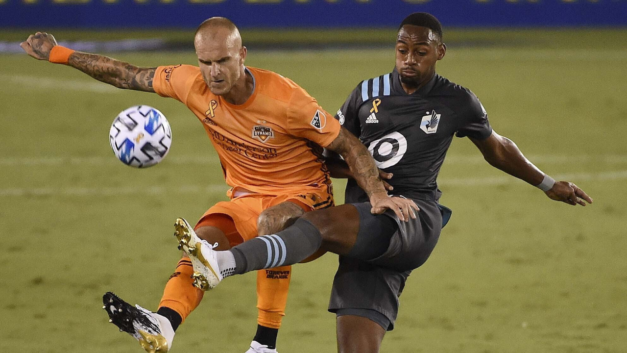 Houston Dynamo defender Aljaz Struna, left, and Minnesota United forward Mason Toye fight for possession during the second half of an MLS soccer match Saturday, Sept. 19, 2020, in Houston. (Eric Christian Smith/Houston Chronicle via AP)