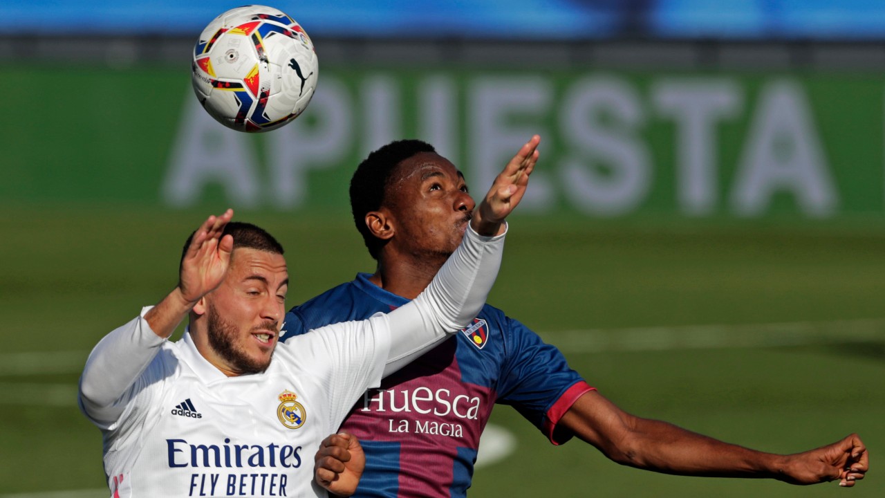 Real Madrid's Eden Hazard, left, goes for a header with Huesca's Kelechi Nwakali during the Spanish La Liga soccer match between Real Madrid and Huesca. (Manu Fernandez/AP) 