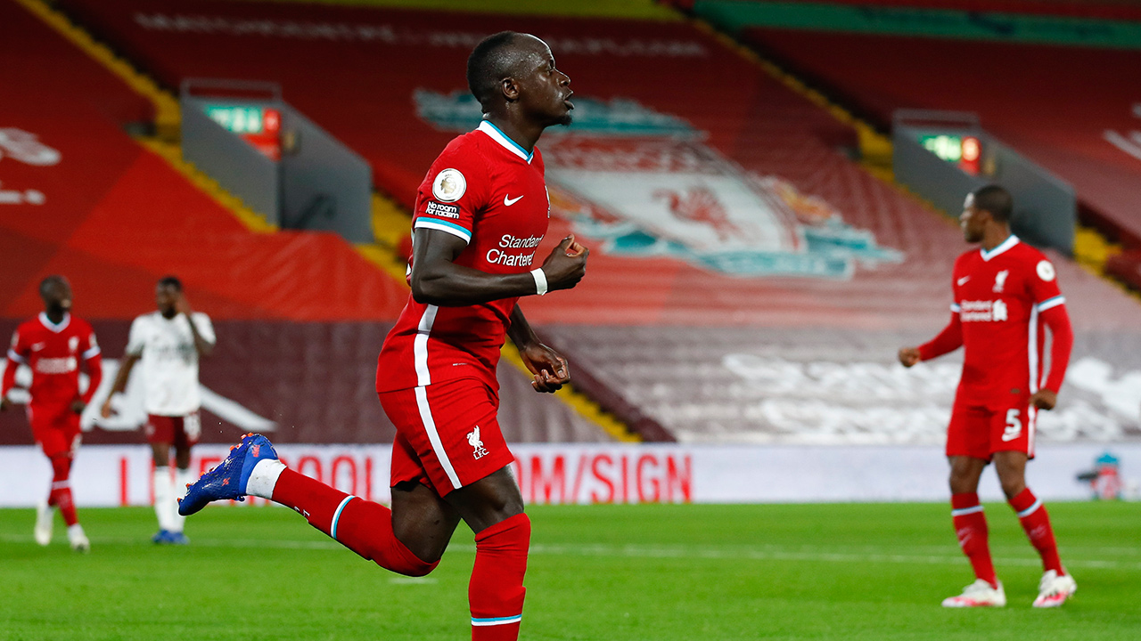 Liverpool's Sadio Mane celebrates after scoring his team's first goal during the English Premier League match between Liverpool and Arsenal at Anfield in Liverpool, England, Monday, Sept. 28, 2020. (Jason Cairnduff/Pool via AP)