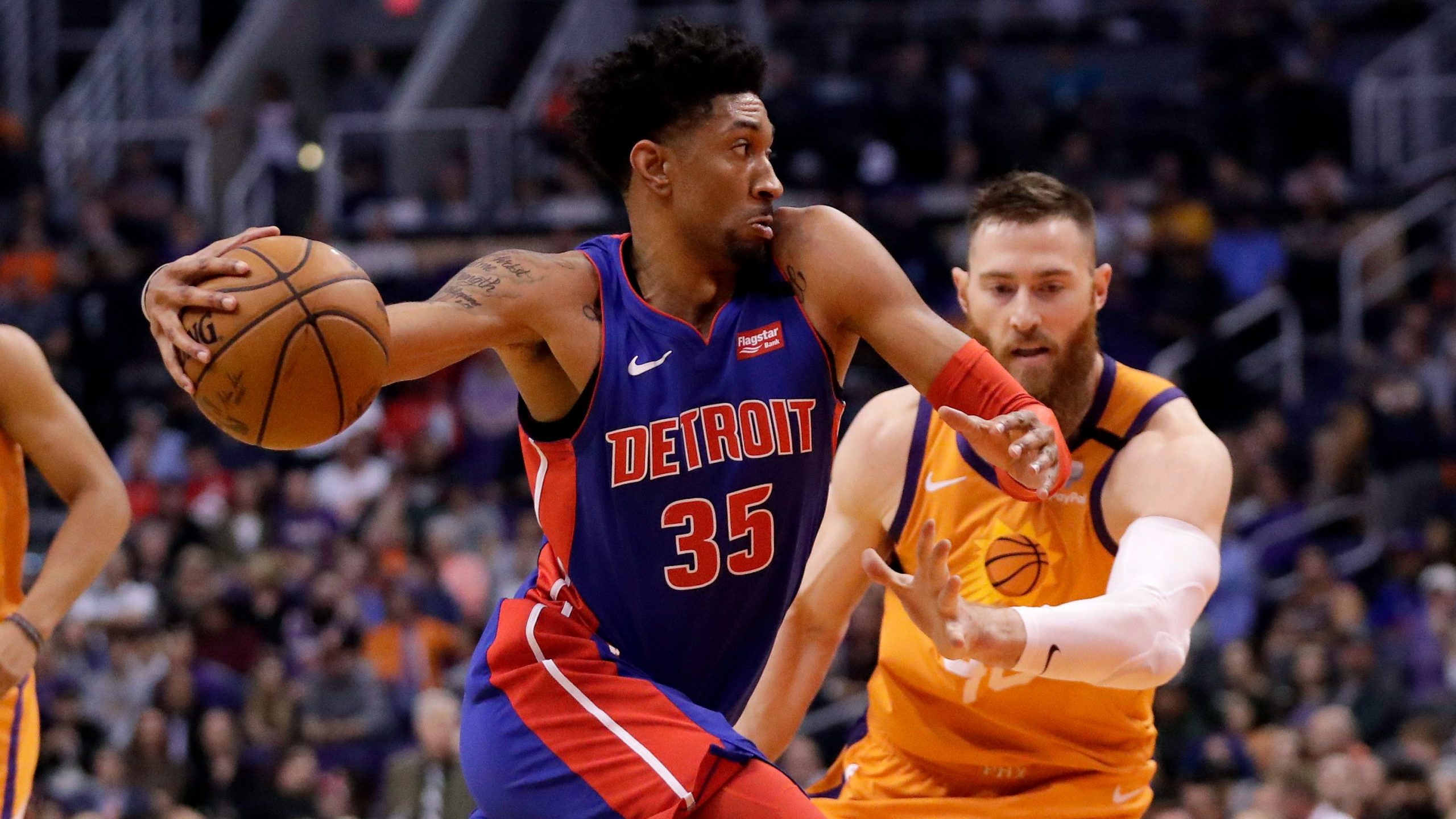 Detroit Pistons forward Christian Wood (35) drives past Phoenix Suns center Aron Baynes during the first half of an NBA game. (Matt York/AP)