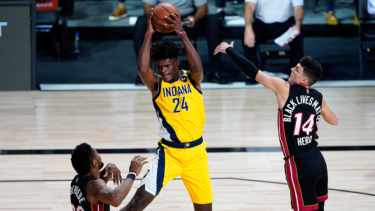 Indiana Pacers' Alize Johnson (24) pulls down a rebound as Miami Heat's Tyler Herro (14) and Chris Silva (30) defend during the first half of an NBA basketball game Monday, Aug. 3, 2020, in Lake Buena Vista, Fla. (Ashley Landis/AP)