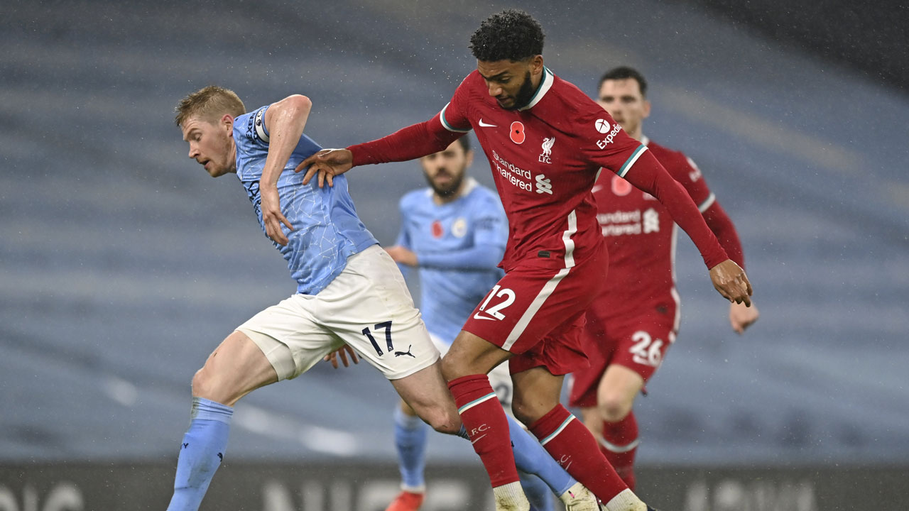 Liverpool's Joe Gomez, right, challenges Manchester City's Kevin De Bruyne during the English Premier League soccer match between Manchester City and Liverpool. (Shaun Botterill/AP)