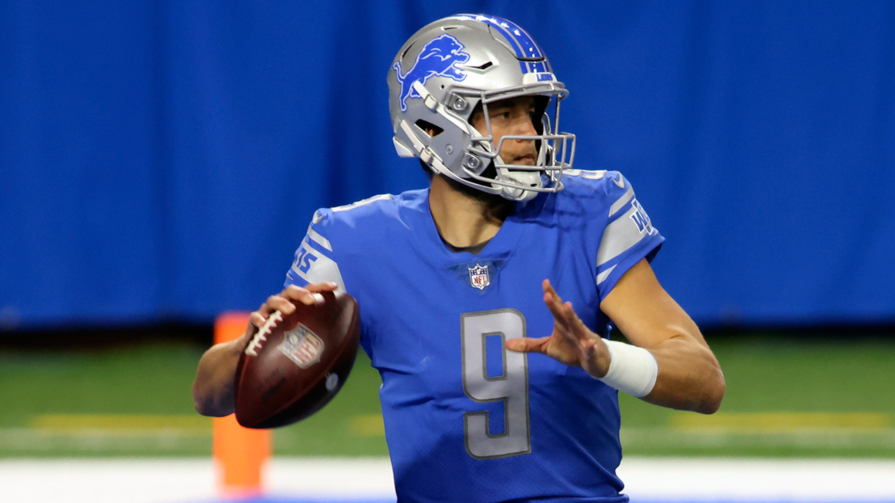 Georgia quarterback Matthew Stafford holds up his Detroit Lions