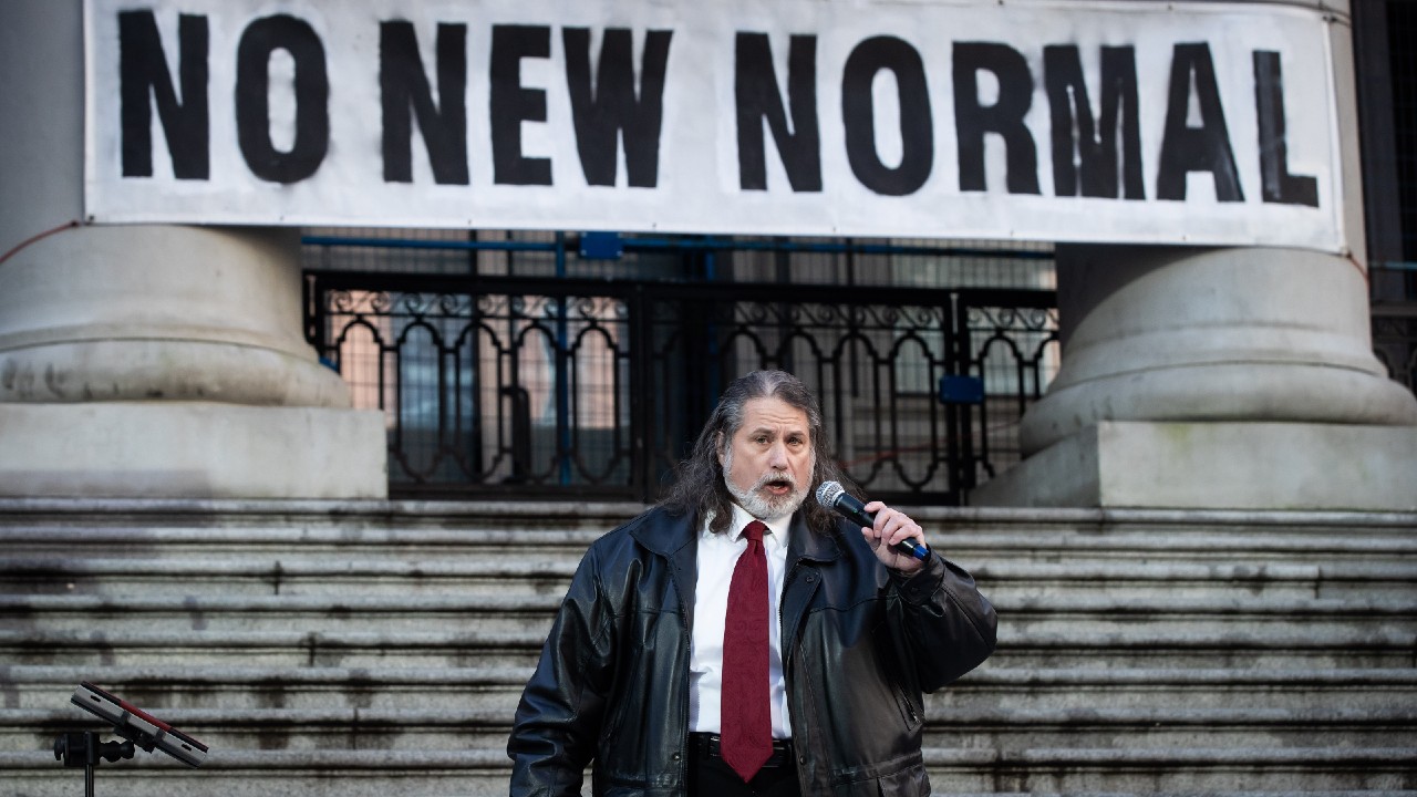 Mark Donnelly, who has been the anthem singer for the Vancouver Canucks NHL hockey team since 2001, performs O Canada at a protest against measures taken by public health authorities to curb the spread of COVID-19, in Vancouver, B.C., Saturday, Dec. 5, 2020. (Darryl Dyck/CP)