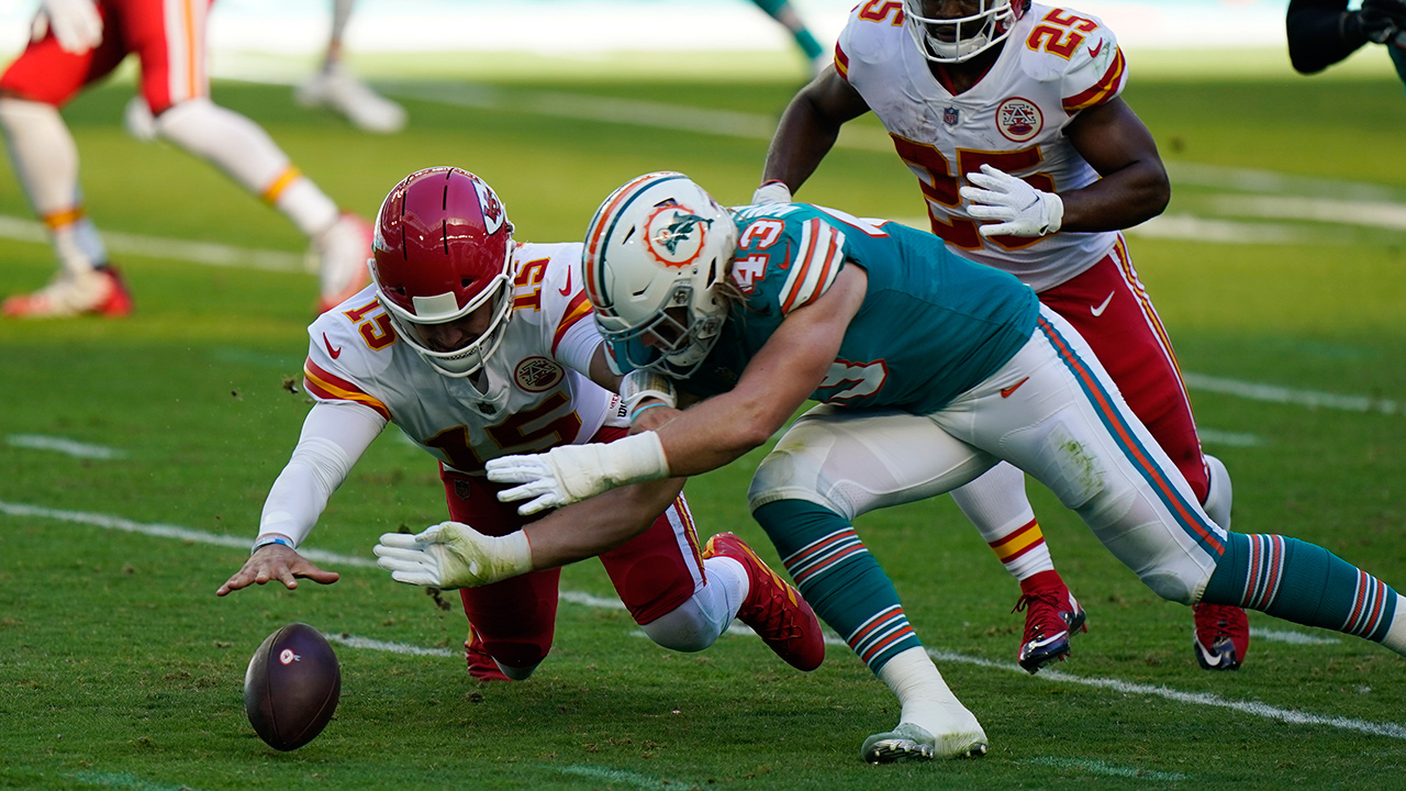 Kansas City Chiefs quarterback Patrick Mahomes (15) and Miami Dolphins outside linebacker Andrew Van Ginkel (43) go after the football after Mahomes fumbled the snap, during the first half of an NFL football game, Sunday, Dec. 13, 2020, in Miami Gardens, Fla. The Chiefs recovered the ball. (Wilfredo Lee/AP)