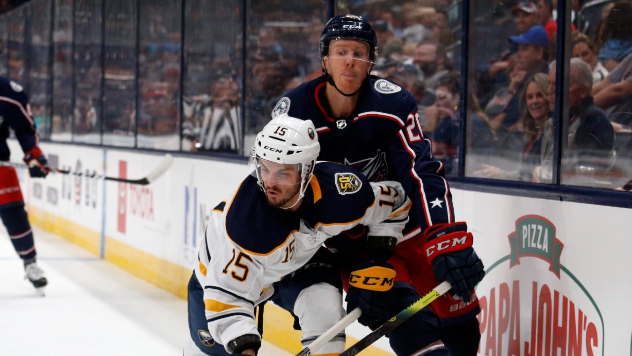 Buffalo Sabres forward Jean-Sebastien Dea, front, reaches for the puck next to Columbus Blue Jackets forward Riley Nash during the second period of an NHL preseason hockey game in Columbus, Ohio, Tuesday, Sept. 17, 2019. (Paul Vernon/AP)