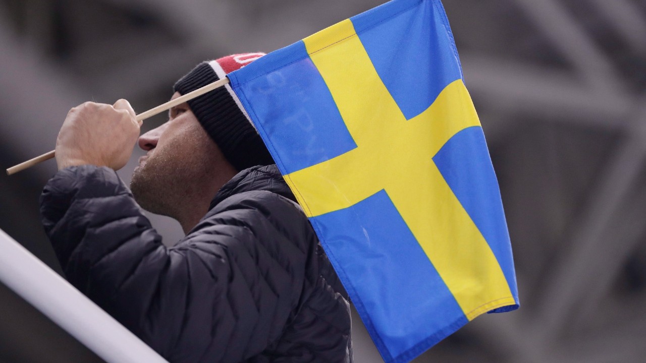 A man poses with a Swedish flag before the preliminary round of the men's hockey game between Sweden and Finland at the 2018 Winter Olympics in Gangneung, South Korea, Sunday, Feb. 18, 2018. (Frank Franklin II/AP)