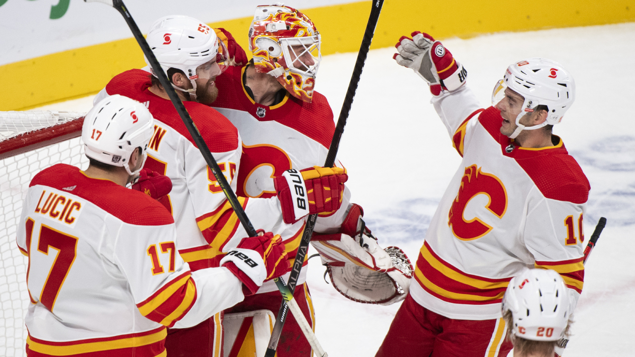 Calgary Flames goaltender Jacob Markstrom celebrates with teammates after defeating the Montreal Canadiens in an NHL hockey game in Montreal, Saturday, January 30, 2021. (Graham Hughes/CP)