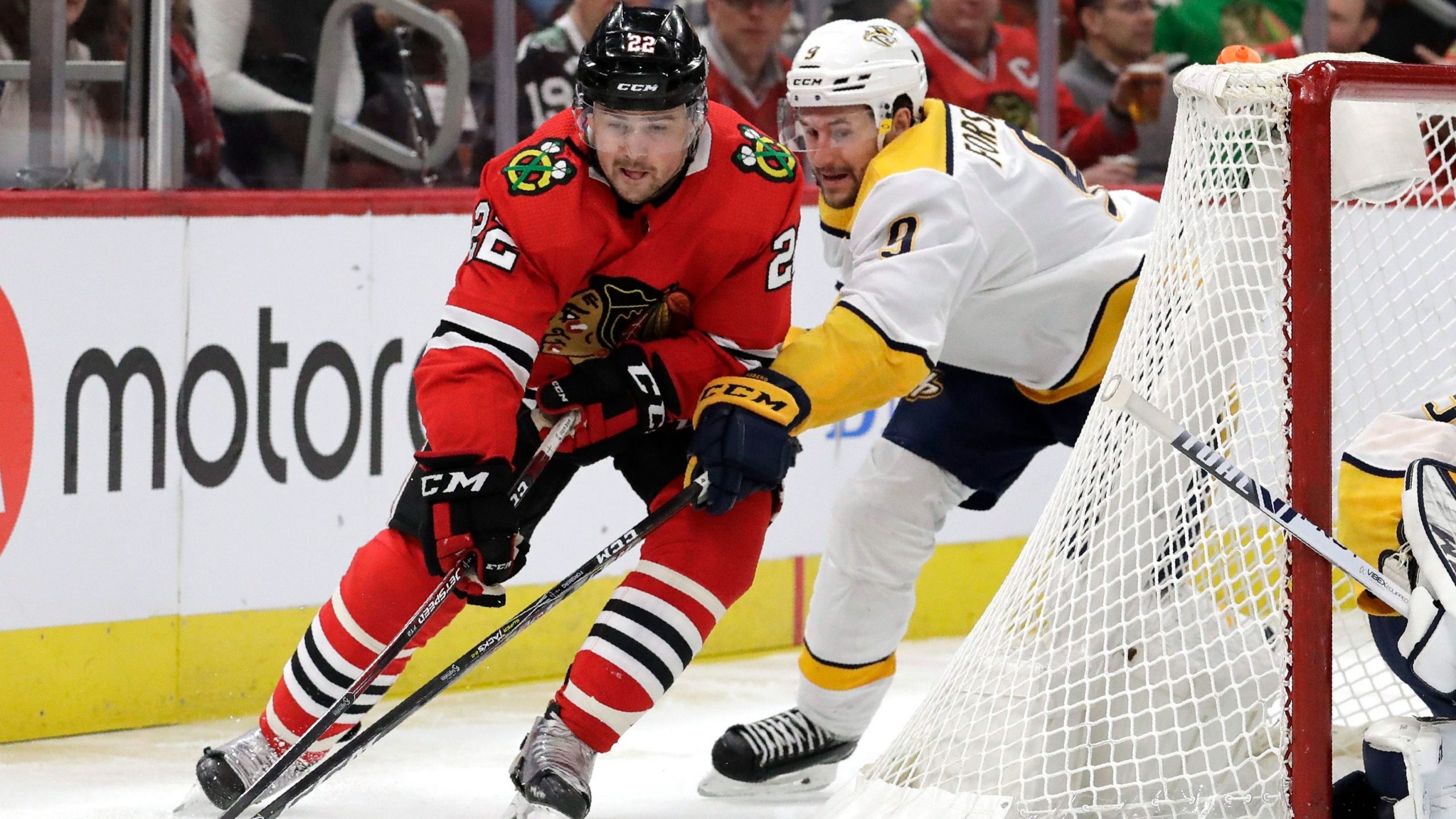 Chicago Blackhawks center Ryan Carpenter, left, and Nashville Predators left wing Filip Forsberg battle for the puck during the first period of an NHL hockey game. (Nam Y. Huh/AP)