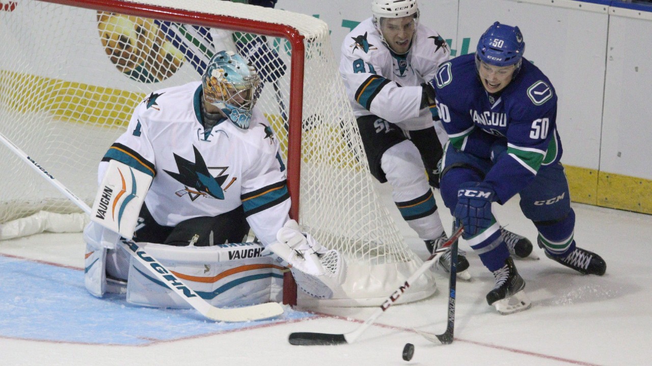 Vancouver Canucks' Brendan Gaunce, right, tries to score on San Jose Sharks' Troy Grosenick, left, during first period of NHL pre-season action at the Q Centre in Victoria, B.C., Monday, September 21, 2015. (Chad Hipolito/CP)