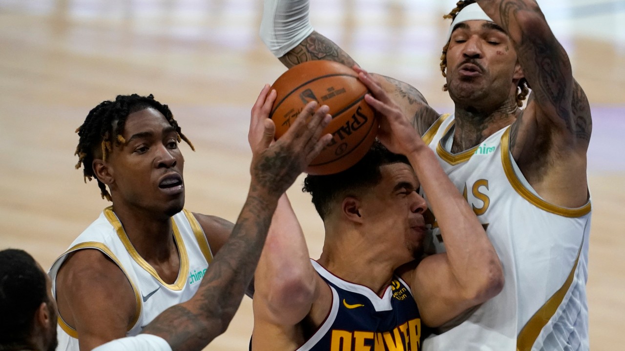 Denver Nuggets forward Michael Porter Jr. (1) is blocked from reaching the basket by Dallas Mavericks' James Johnson, left, Wes Iwundu, center rear, and Willie Cauley-Stein, right, in the second half of an NBA basketball game. (Tony Gutierrez/AP)