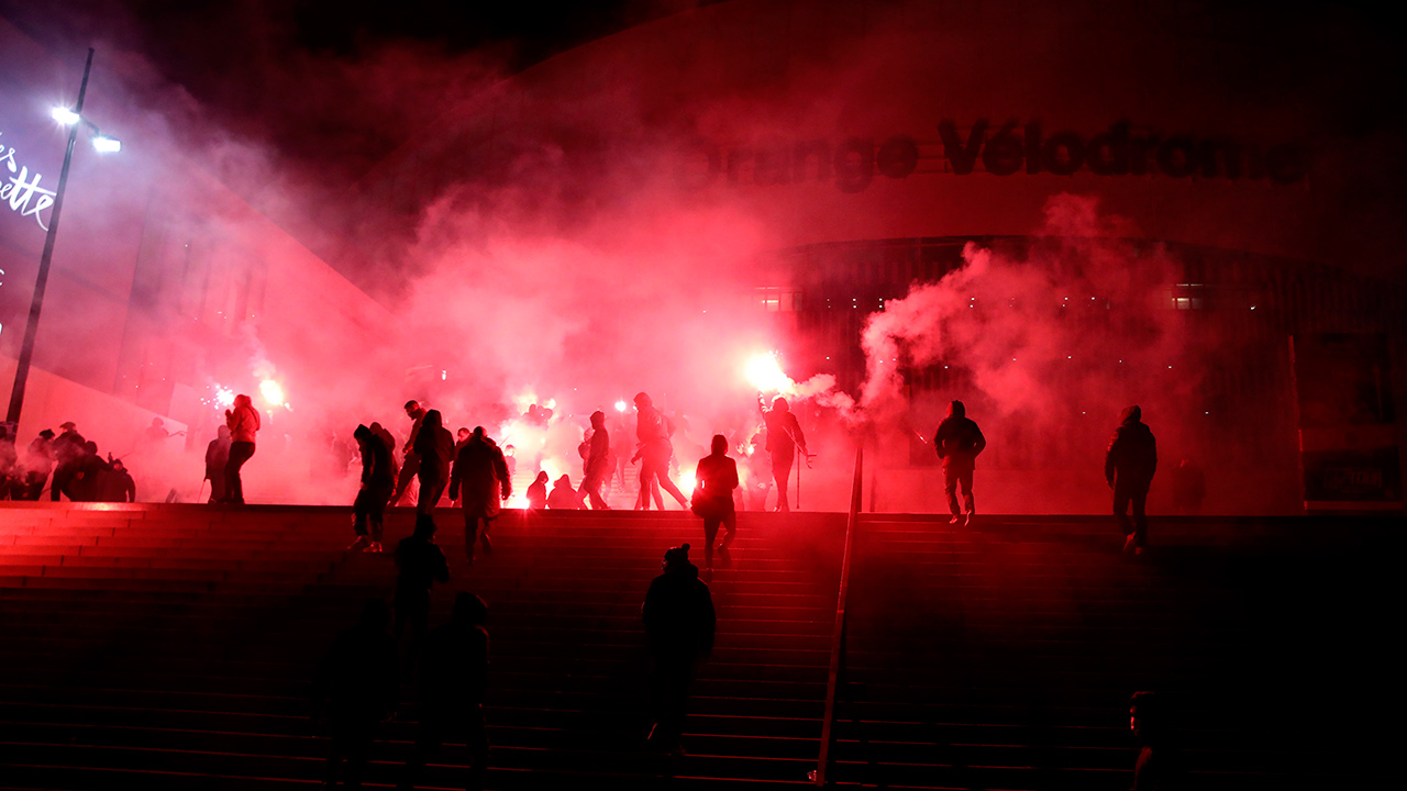 Marseille fans use flares as they protest before the French League One soccer match between Marseille and Montpellier outside of the Stade Velodrome in Marseille, southern France, Wednesday Jan. 6, 2021. (Daniel Cole/AP)