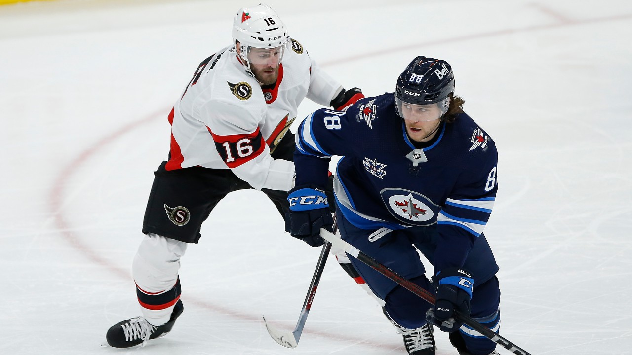 Ottawa Senators' Austin Watson (16) chases down Winnipeg Jets' Nathan Beaulieu (88) during first period NHL action in Winnipeg on Thursday, February 11, 2021. (John Woods / CP)